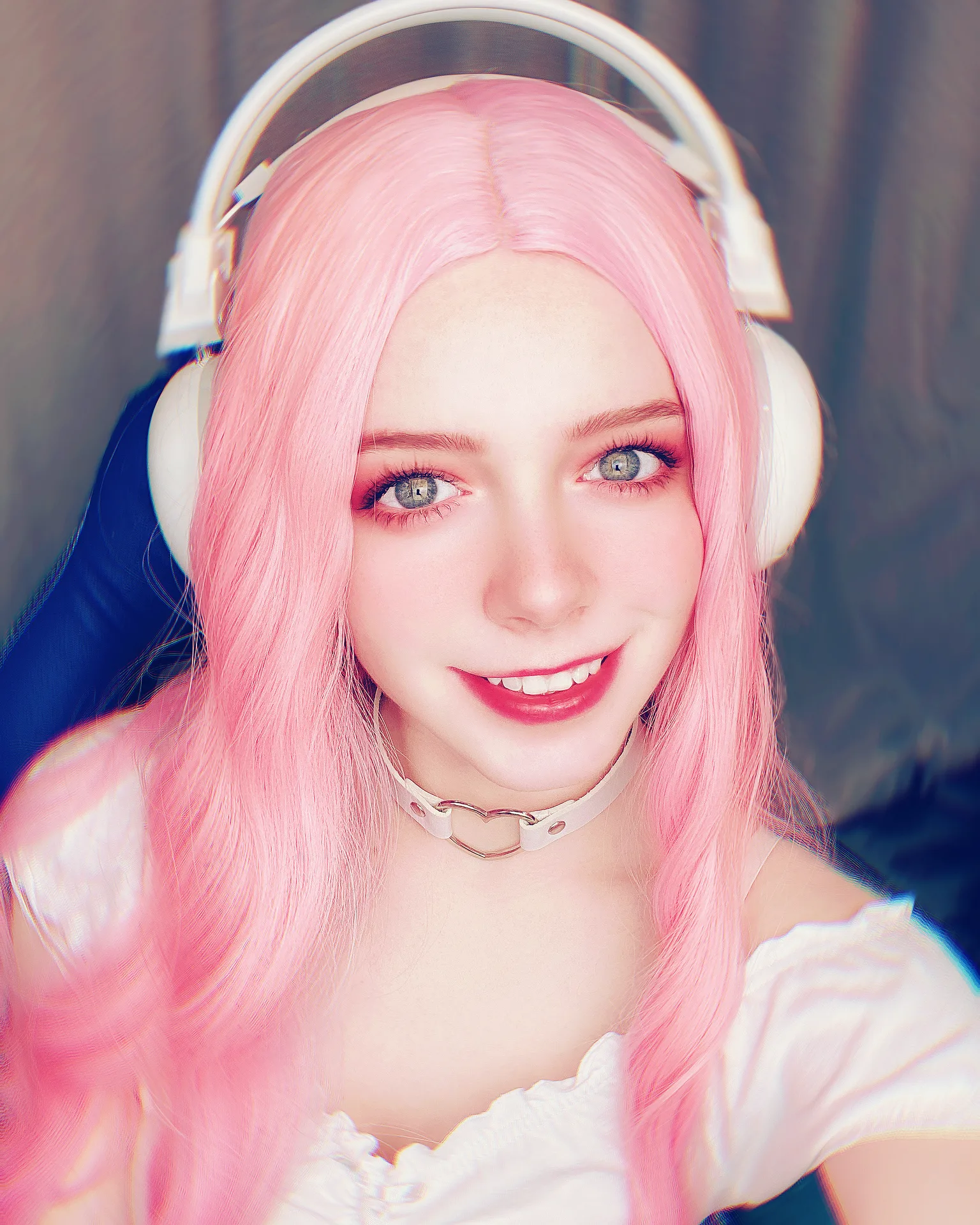 Pink hair, headphones, and a white top