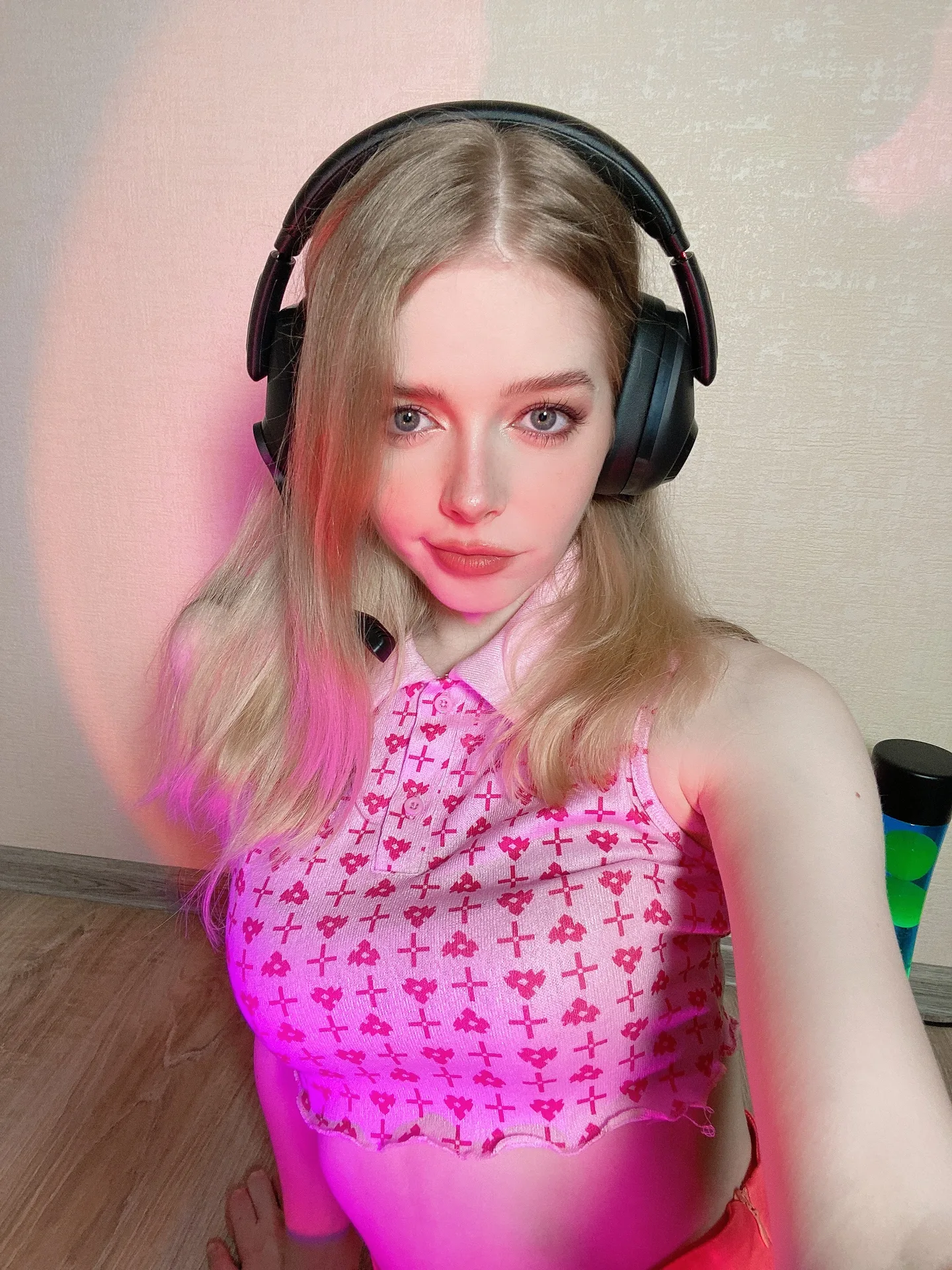 Pink patterned top and headphones