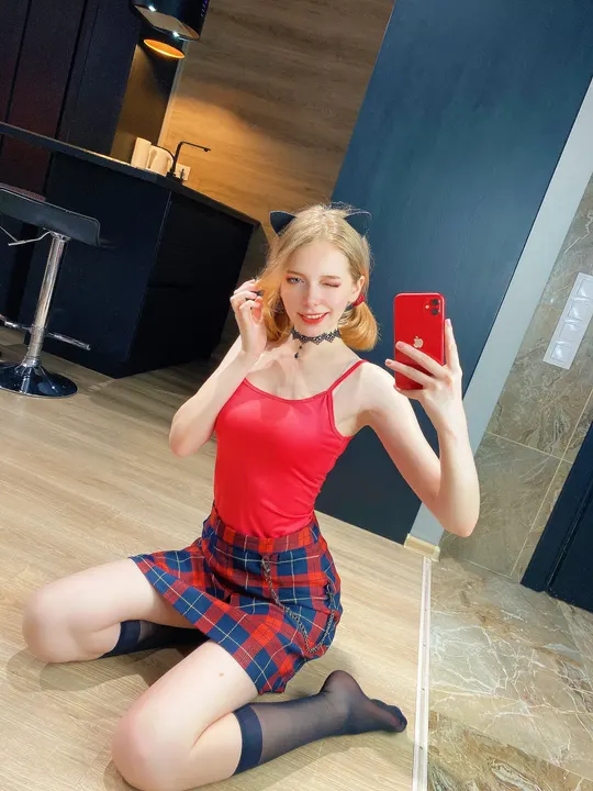 Red top and plaid skirt selfie
