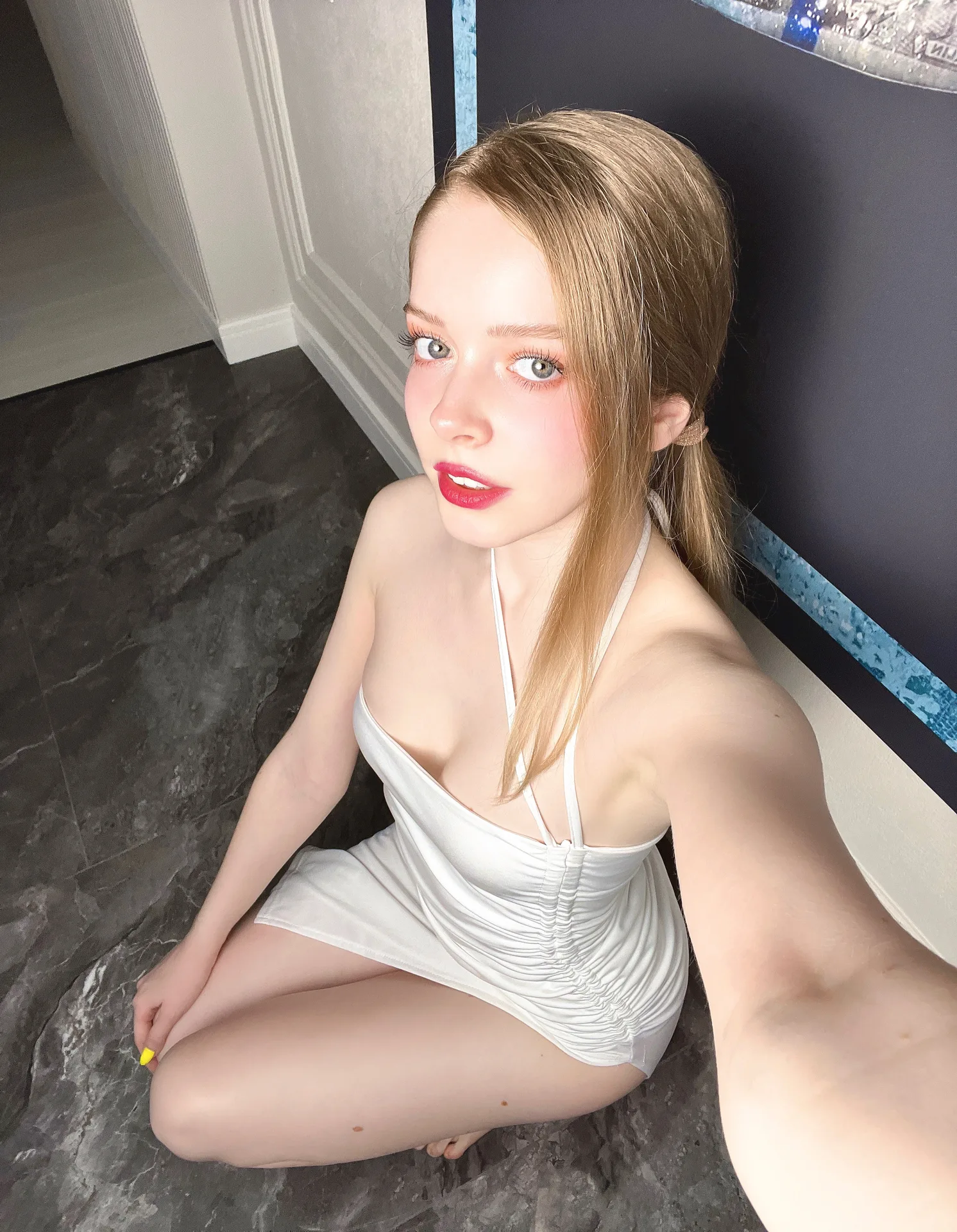White ruched dress on a dark floor