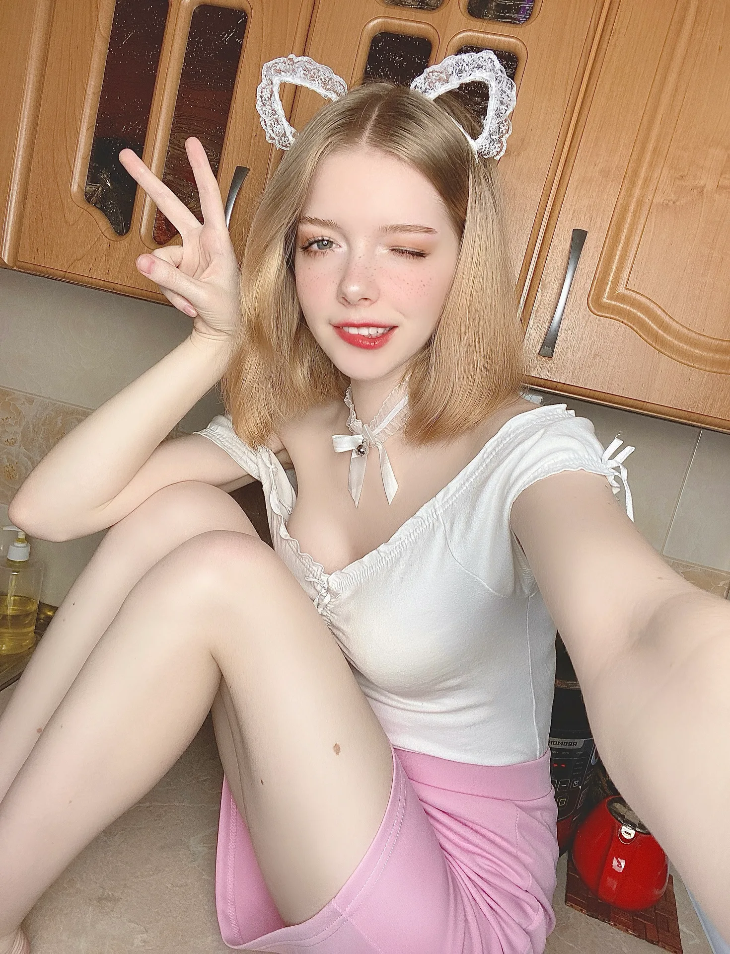White top and pink skirt in a kitchen